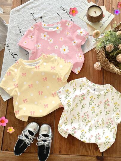 SHEIN Bộ 3 áo thun nữ trẻ em tay ngắn cổ tròn phong cách tối giản casual, họa tiết hoa cúc, cây và nơ, màu kem trắng, kem hồng, kem vàng, phù hợp đi học, đi chơi, dạo phố, du lịch, họp mặt, mùa xuân và mùa hè