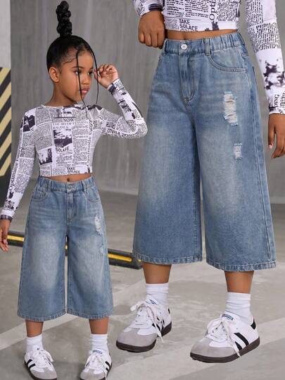 SHEIN Explorewe Quần jean lửng 7/8 thời trang cho bé gái tuổi teen, chất liệu nhẹ, kiểu dáng mới mùa hè, thiết kế đường phố năng động, quần jean lửng dáng rộng 5 túi cơ bản, chất liệu denim cotton mềm mại, phù hợp cho mặc hàng ngày, dự tiệc, đi học, đi làm.