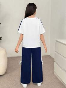 SHEIN Bộ đồ thể thao 2 món cho bé gái tuổi teen, kiểu dáng retro, tay raglan rộng thùng thình, phối màu tương phản, in nơ, cổ tròn và quần nỉ ống đứng, màu xanh & trắng. - Xanh và trắng - Xem 2