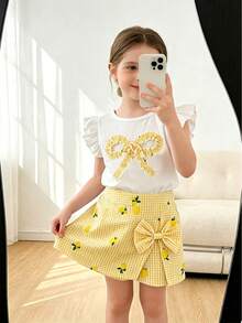 Elladie kids Bộ đồ thường ngày 2 món cho bé gái: Áo cổ tròn ôm dáng mềm mại, dáng suông, phối vàng và trắng kẻ caro, tay bồng, nơ, gồm áo vàng chanh và quần kẻ caro có nơ. - Màu vàng - Xem 1