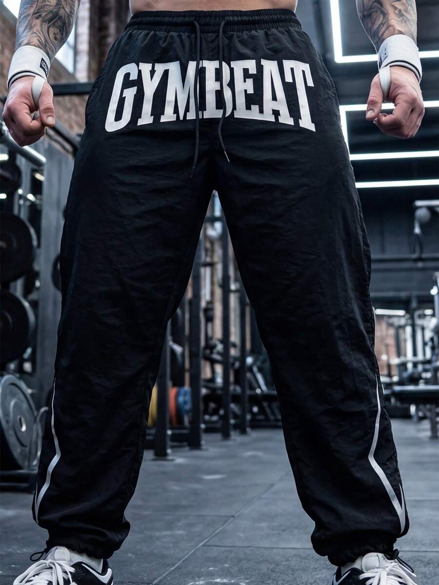 GymBeat Men's Woven Letter Graphic Drawstring Waist Sports Pants, Gym - Black - View 1