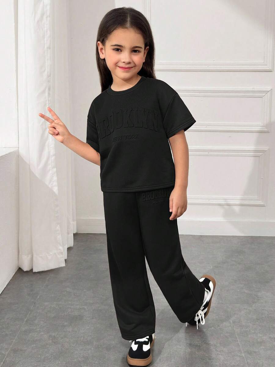 SHEIN Conjunto de camiseta de manga corta con cuello redondo y hombros caídos & pantalones largos, estilo suelto, casual, minimalista y cómodo para niñas jóvenes - Negro - Ver 1