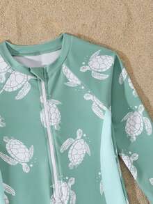 SHEIN 男童泳衣一件装，以莫兰迪安灰绿色为底色，饰以白色海龟剪影和泡泡印花，侧边配有浅蓝色条纹，适合度假、夏季、海滩、泳池、节日派对和休闲游泳。 - 彩色 - 查看 6