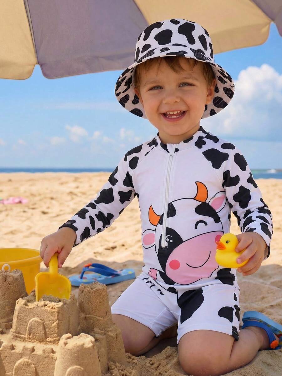 SHEIN Bộ 2 món gồm áo tắm dài tay và mũ bơi họa tiết bò sữa dễ thương dành cho bé trai, thích hợp cho kỳ nghỉ xuân/hè, ở nhà, ngoài trời, du lịch, bãi biển, hồ bơi, tiệc tùng. - Màu xanh lam - Xem 1