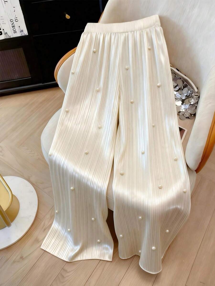 GlowEve CURVE Quần ống rộng dáng suông thanh lịch cỡ lớn, chất liệu ánh ngọc trai, thiết kế xếp ly giúp thon gọn vóc dáng, phù hợp cho đi làm hàng ngày, hẹn hò, dự tiệc và các dịp trang trọng. - Màu be - Xem 1