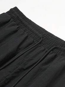 GymBeat Quần thể thao nam in chữ, có túi, cạp chun, dây rút - màu đen - Xem 5