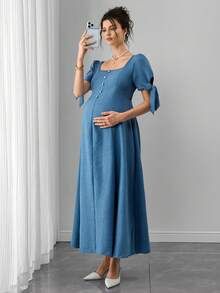 Đầm bầu có dây buộc nơ, xếp ly, cài cúc phía trước, dáng chữ A, tay ngắn. - Màu xanh nhạt - Xem 1