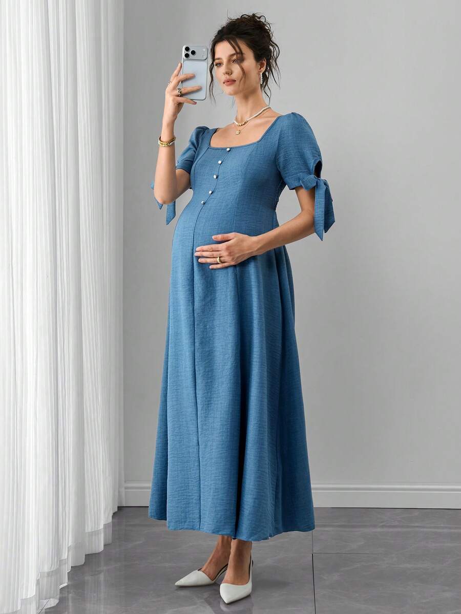 Đầm bầu có dây buộc nơ, xếp ly, cài cúc phía trước, dáng chữ A, tay ngắn. - Màu xanh nhạt - Xem 1