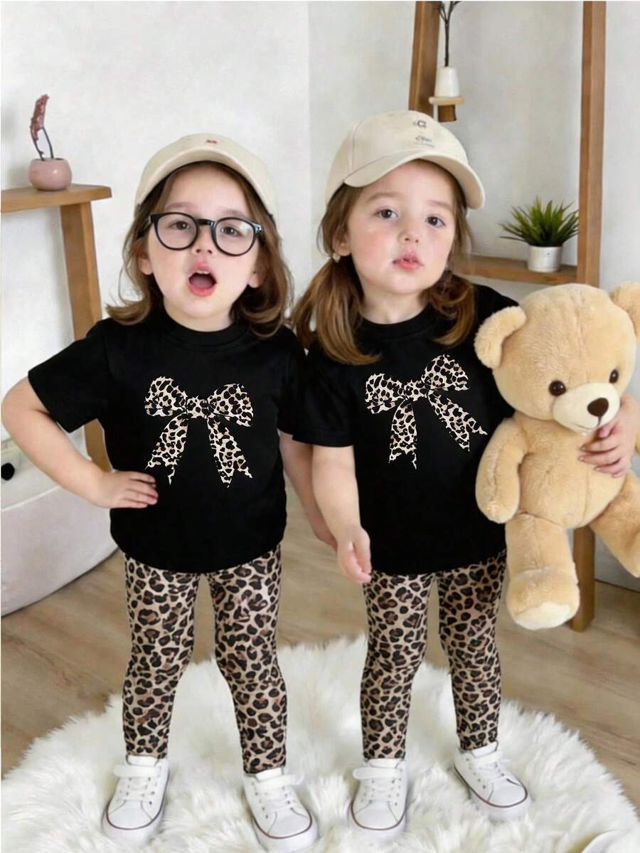 SHEIN Playful Pals Baby Girls' Cute Bow Print White Round Neck Short Sleeve Top Paired With Comfortable Leopard Print Casual Pants, T-Shirt Set, Spring/Summer