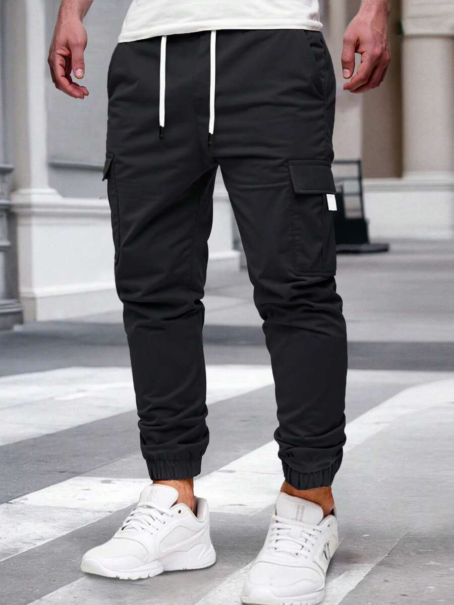 Manfinity Homme Pantalones cargo para hombre con cintura elástica y cordón, bolsillos cargo, ajuste relajado y puños en los tobillos, pantalones cargo casuales para hombre, otoño - Negro - Ver 1