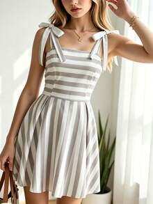 SHEIN Đầm hai dây kẻ caro thanh lịch dành cho thiếu nữ. Được làm từ vải kẻ caro nhỏ màu xám và trắng, kết hợp với cổ áo có ve và dây đeo nơ có thể tháo rời, mang hơi hướng phong cách ngọt ngào Pháp; phần eo được thắt lại và kiểu dáng chân váy đặc biệt tạo nên sự vừa vặn và nét thoải mái. Một chiếc đầm nữ tinh tế đang được ưa chuộng trong những năm gần đây, phù hợp để mặc hàng ngày vào mùa hè. - Nhiều màu - Xem 4