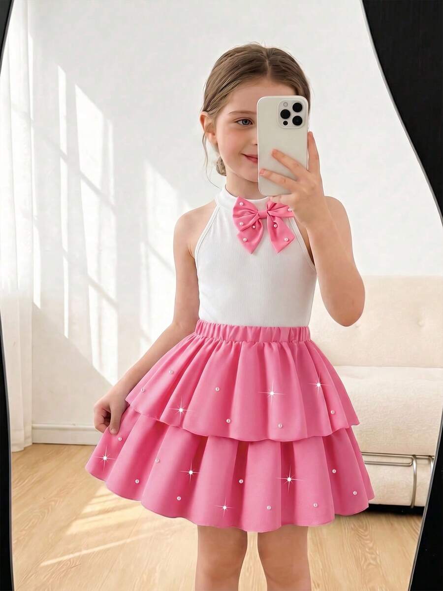 Elladie kids 两件套女童派对珍珠蝴蝶结套装,白色露背罗纹上衣饰有珍珠蝴蝶结,搭配红色层叠蛋糕裙,裙摆饰有珍珠,散发优雅甜美的派对气息,适合日常外出、生日派对、家庭聚会,是幼儿的完美夏季服装。 - 粉色 - 查看 1