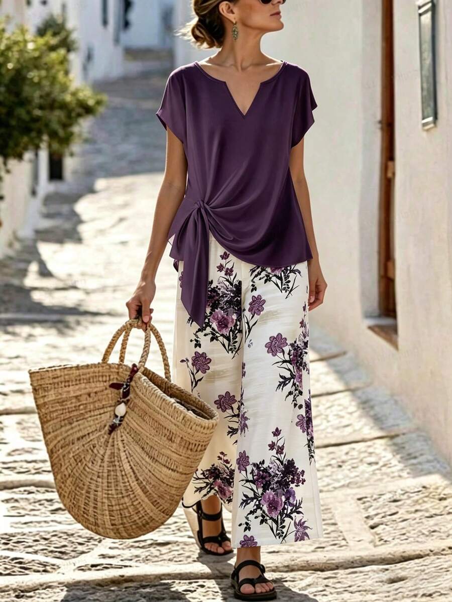 SHEIN Holidaya Bộ đồ hai mảnh thanh lịch dành cho nữ: áo tay ngắn cổ tròn hoặc cổ chữ V dáng rộng, thắt eo, vai rớt và quần ống rộng họa tiết hoa, thích hợp cho mùa hè, kỳ nghỉ xuân, lễ Phục sinh, ngày Thánh Patrick, đi biển, dã ngoại. Bộ đồ hai mảnh sang trọng, áo kiểu thanh lịch cho nữ, trang phục ngày lễ, bộ đồ thường ngày cho nữ, họa tiết hoa, áo tím, quần trắng, dáng rộng và thoải mái, cổ chữ V, thắt eo. - Màu tím - Xem 1