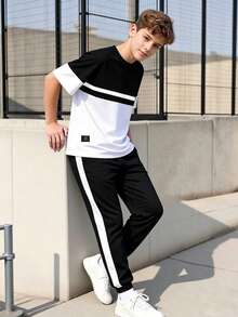 Vacaura 2 pezzi/set Maglietta a girocollo casual e pantaloni sportivi con stampa a blocchi di colore in contrasto per ragazzi adolescenti, tessuto confortevole, vestibilità slim, adatto per più stagioni - Bianco e nero - Visualizzare 1