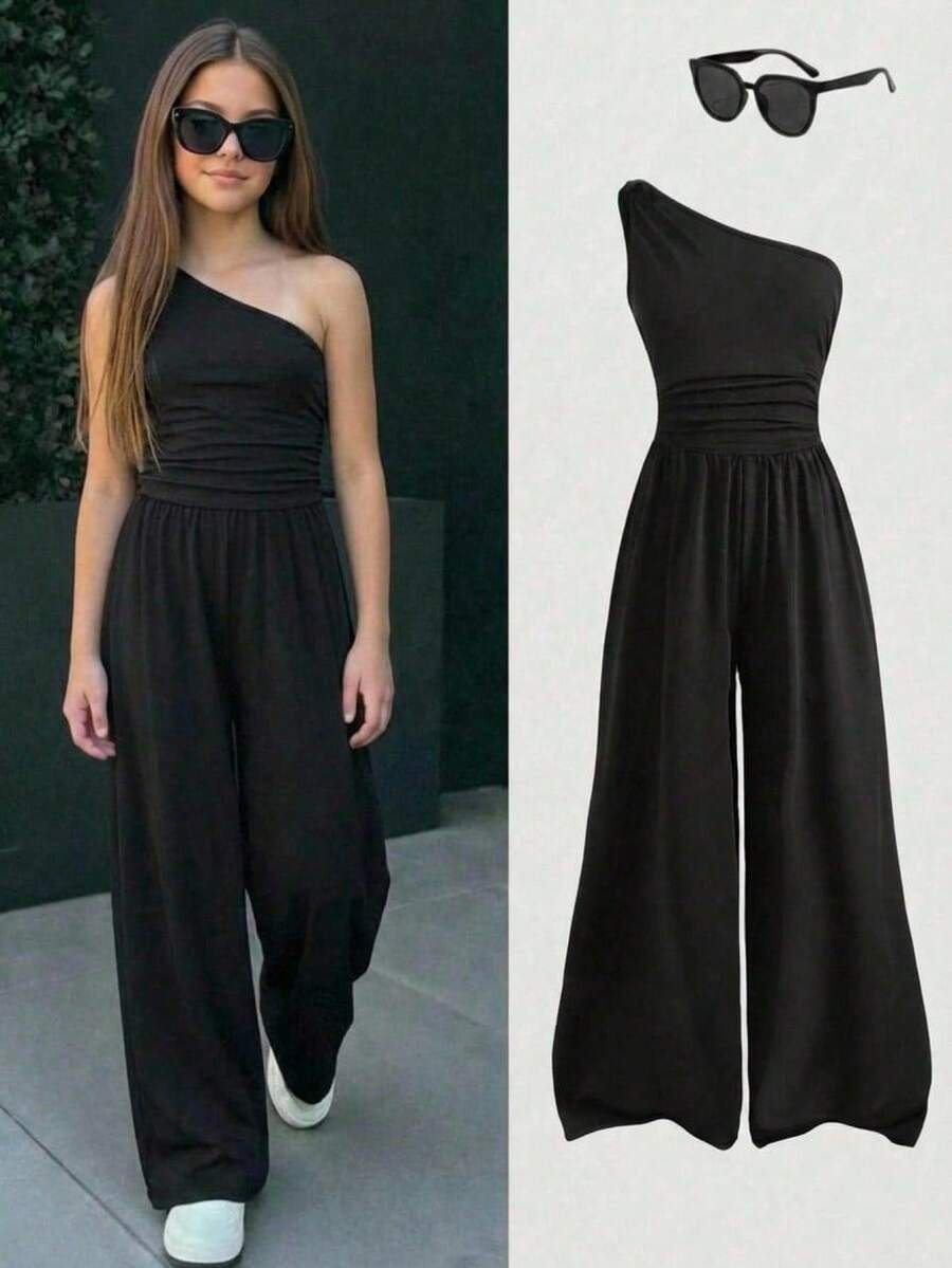 SHEIN Bộ jumpsuit đen lệch vai dành cho nữ tuổi teen, thiết kế dây đeo vai đơn, dáng xếp ly eo, chất liệu thân thiện với da, kiểu dáng thời trang, nhẹ nhàng, phù hợp cho mùa hè, và độc đáo, ngọt ngào và cá tính. - màu đen - Xem 1
