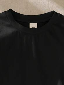 SHEIN Camiseta casual holgada para niña con cuello redondo y dobladillo con volantes de unicolor - Negro - Ver 4