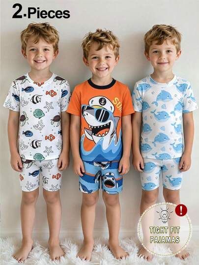 Bộ đồ ngủ ngắn tay và quần short in hình cá mập hoạt hình dành cho bé trai, ôm sát.