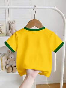 Áo thun ngắn tay cổ tròn ôm sát, màu vàng nắng rực rỡ, họa tiết ngôi sao vàng, vàng kim, kiểu retro thời trang với chữ BRAZIL, cổ áo tương phản, thích hợp mặc hàng ngày vào mùa xuân và hè, đi chơi, thể thao, World Cup, kỳ nghỉ, lễ hội, trang phục mùa xuân và hè, thoải mái, phong cách cho bé gái, trang phục thường ngày, áo thun in chữ thể thao retro cho trẻ em, kiểu dáng mới, trang phục dự tiệc, trang phục thư giãn, trang phục trở lại trường học. - Nhiều màu - Xem 2