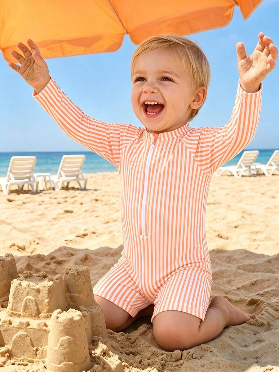 SHEIN 男婴泳衣，连体泳衣，拉链闭合，数码针织条纹印花。夏季海滩度假必备时尚单品。这款长袖短裤泳衣非常适合夏季穿着，是度假的理想之选，也适合可爱的小男孩在海滩玩耍和度假时穿着。