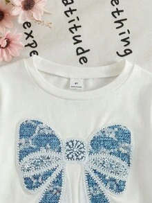 SHEIN 两件套女童针织白色纯色圆领休闲T恤和梭织碎花休闲裤套装，白色上衣饰有蝴蝶结装饰印花，适合4岁和5岁女孩穿着，舒适宽松的牛仔裤，适合女孩夏季穿着，可爱童装套装，适合女孩度假休闲穿着。 - 彩色 - 查看 6