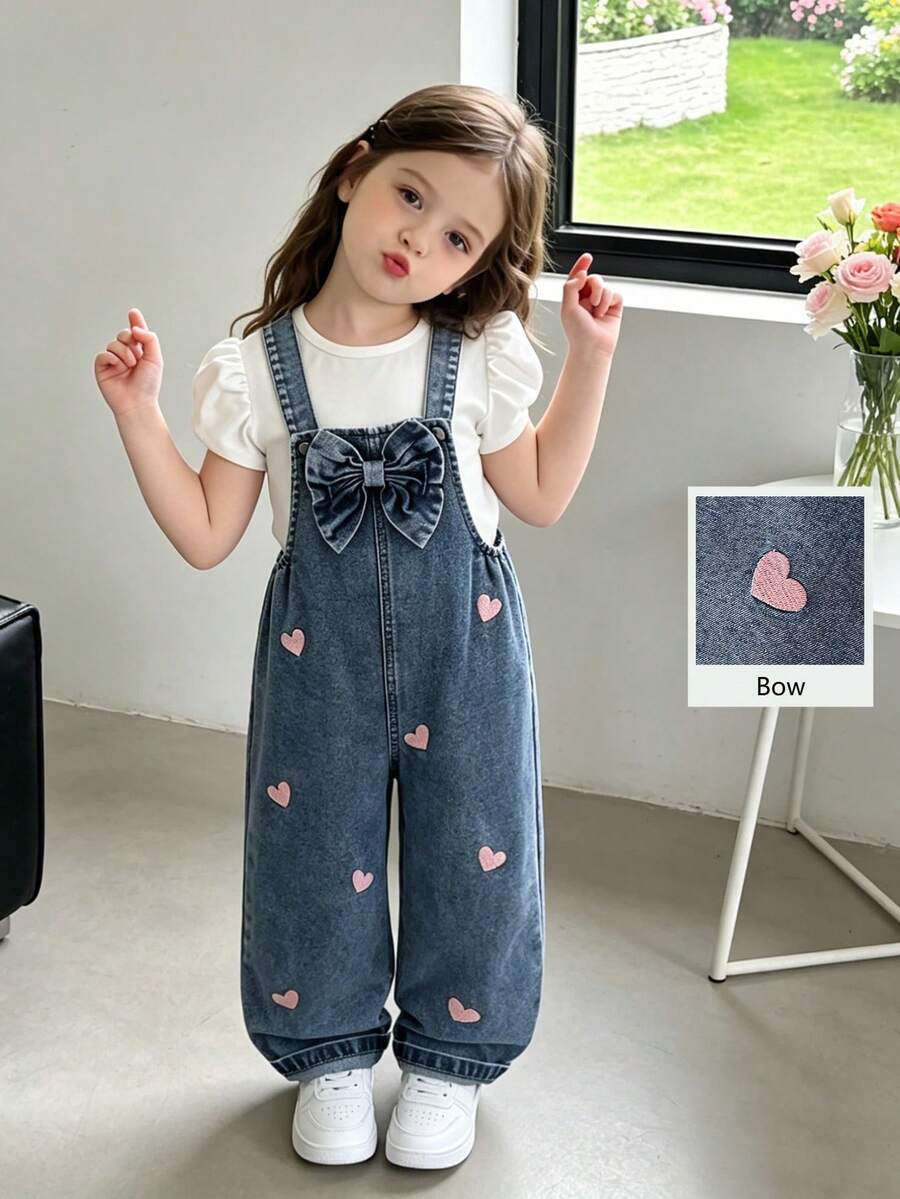 SHEIN Genkimix Kids 女童时尚百搭牛仔背带裤，春夏秋冬皆宜，复古中蓝色牛仔布，粉色爱心刺绣点缀，胸前饰有大蝴蝶结，宽松直筒裤型，面料柔软舒适，适合日常外出和上学穿着。