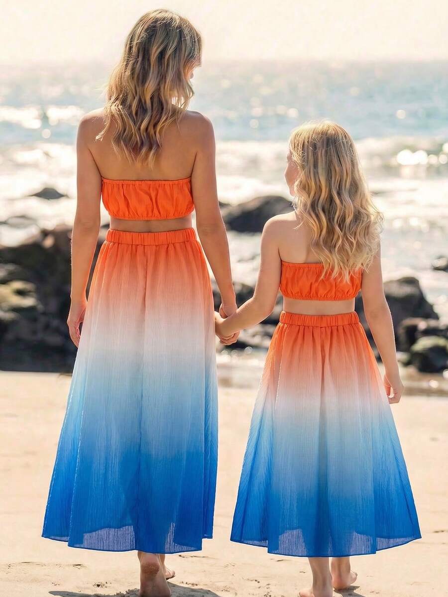 Đầm không tay cổ yếm ombre cho bé gái, chất liệu mềm mại chuyển màu từ cam ấm sang trắng tinh khiết rồi xanh đậm, thiết kế nhiều lớp, eo khoét, cạp chun co giãn tốt, thích hợp cho kỳ nghỉ biển, dạo chơi ven biển, dã ngoại mùa hè, chất liệu nhẹ, thời trang xuân/hè 2026. - Nhiều màu - Xem 1