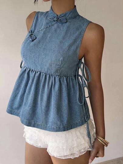 Aloruh Women's Casual Sleeveless Side Slit Tie-Up Denim Blouse, Summer,Light Wash Denim Qipao-Style Babydoll Top With Knot Buttons & Side Ties,Coquette Denim Peplum Top With Mandarin Collar And Lace-Up Sides,Vintage Denim Babydoll Blouse With Frog Closures And Gathered Hem,A Light Wash Denim Babydoll Top Featuring A Mandarin Collar With Traditional Frog Closures, Side Lace-Up Ties, And A Gathered Peplum Hem. A Blend Of Coquette And Chinese-Inspired Styles, Perfect For Casual Wear,DenimBabydollTop, QipaoStyle, MandarinCollar, FrogButtons, SideLaceUp, LightWashDenim, CoquetteStyle, ChineseInspired