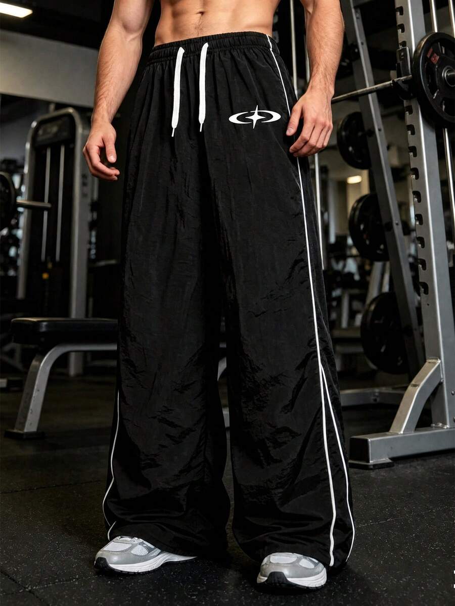 GymBeat Quần thể thao nam màu đen kẻ sọc bên hông, kiểu dáng tối giản, ống rộng suông, phong cách đường phố hiện đại, quần jogger ống rộng đa năng kiểu Mỹ. - màu đen - Xem 1