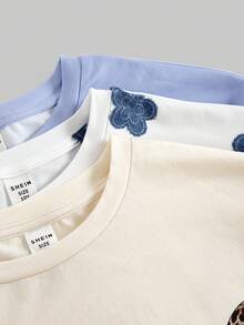 Girlism 3件套少女T恤套装，春夏新品：1. 复古豹纹蝴蝶结装饰款，2. 淡紫色波西米亚雏菊图案款，3. 复古简约花卉设计款。休闲圆领宽松T恤搭配修身短裤，适合春夏日常穿着和街头风。 - 彩色 - 查看 7