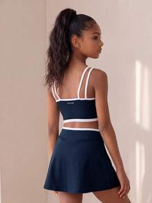 SHEIN Conjunto activo azul marino para niñas preadolescentes - Conjunto de top de tirantes y falda con diseño de color contrastante, tela suave y de gran elasticidad para fitness, tenis, trotar y deportes - Azul Marino - Ver 1