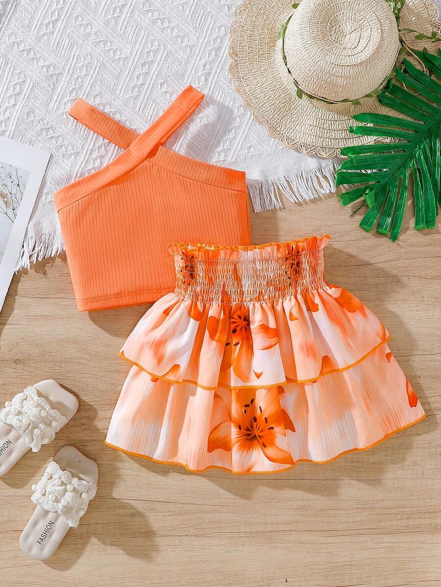 Bộ đồ thể thao mùa hè cho bé gái, gồm áo tank top không tay cổ yếm ôm sát và chân váy xếp ly họa tiết hoa nhiệt đới cạp chun, thích hợp cho kỳ nghỉ hè và các hoạt động dã ngoại. - trái cam - Xem 1