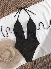 Swim Vcay 这款女士米色针织连体泳衣采用垂直针织面料，弹力十足，修身显瘦（收腰而不紧绷）。深V领设计，搭配棕色波浪纹饰边和装饰性海星点缀，尽显海滨风情。露背双系带设计，可根据个人身材调整松紧，性感又不失度假风情。 - 黑色 - 查看 5