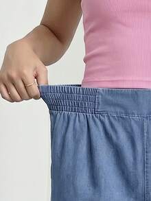 SHEIN Calça jeans feminina para adolescentes, lançamento 2026, estilo casual e moderno para o verão. Jeans azul médio, cintura elástica com pregas, modelagem reta e solta. Confeccionada em tecido jeans leve e macio, confortável e agradável ao toque. Uma peça essencial para meninas, com estilo minimalista e casual, perfeita para o verão, uso diário, ensaios fotográficos, passeios, festas, festivais de música, férias e muito mais. - Lavagem Média - Ver 6