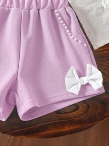 SHEIN Elladie kids Conjunto elegante y lindo para niña con camisa de cuello Peter Pan, botones de perla y mangas con volantes, talla grande shorts cortos con lazo y perlas - Morado - Ver 6