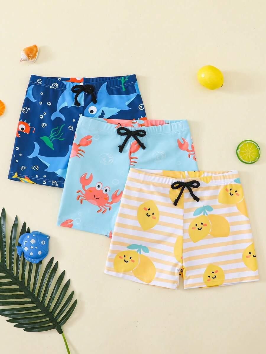 SHEIN 男童休闲度假网纱多巴胺鲨鱼、螃蟹、海洋生物、条纹、柠檬水果印花宽松梭织沙滩泳装套装,三件套短裤,泳衣,春夏沙滩装 - 彩色 - 查看 1