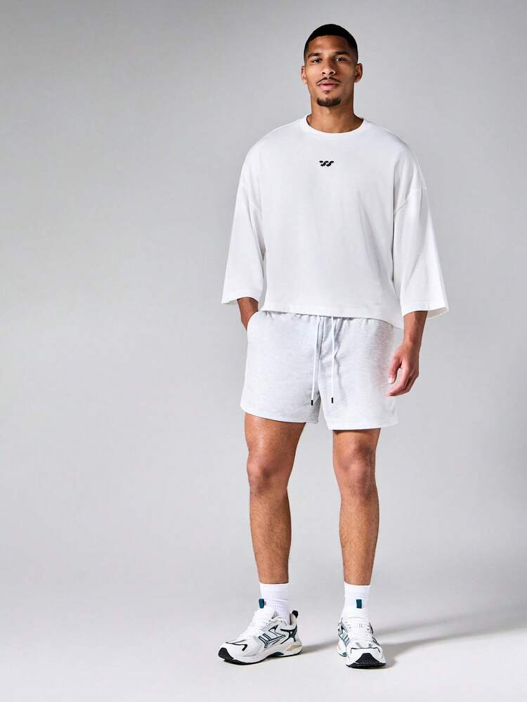 Short en maille chiné avec cordon de serrage à la taille, poches latérales et détail d'étiquette de marque, pour l'été