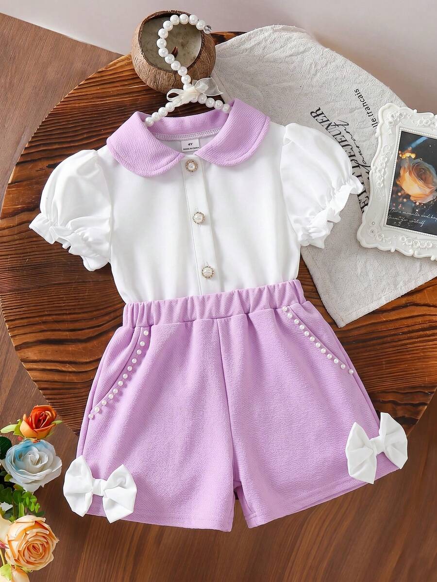 SHEIN Elladie kids Conjunto elegante y lindo para niña con camisa de cuello Peter Pan, botones de perla y mangas con volantes, talla grande shorts cortos con lazo y perlas - Morado - Ver 1