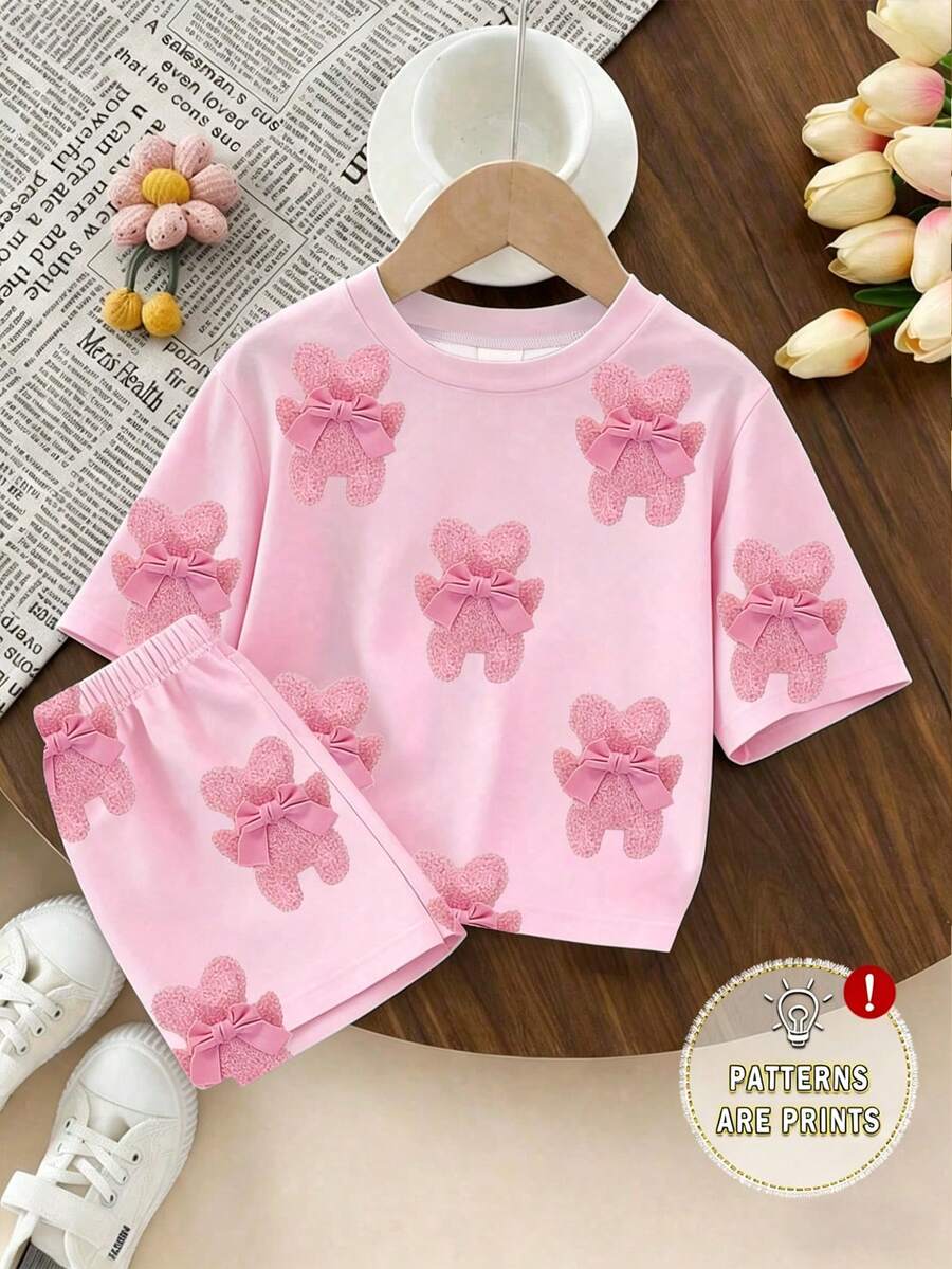 Bộ đồ thể thao thoải mái, thời trang, ngọt ngào, dễ thương, tối giản với họa tiết gấu bông và nơ cho bé gái, gồm áo thun ngắn tay và quần short, thích hợp mặc từ xuân sang hè, phù hợp cho hoạt động ngoài trời, màu hồng nhạt tươi mát cho mùa hè. - Nhiều màu - Xem 1