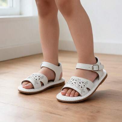 Sandalias blancas para niña con flores caladas y correa ajustable