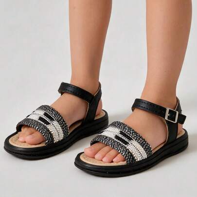 Sandalias negras para niña con tiras brillantes y correa ajustable