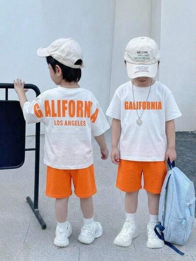 SHEIN 2pcs/Set Young Boys Casual Street Cute Vacation Print Pattern Oversized Round Neck Short Sleeve White & Blue Striped Drop Shoulder T-Shirt And Blue Shorts Set, Suitable For Spring/Summer