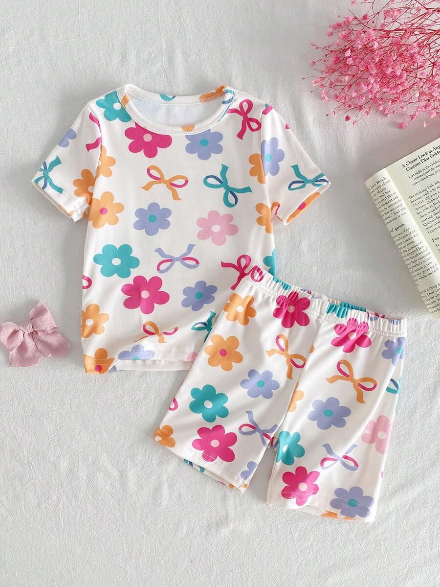 SHEIN Bộ đồ mặc nhà thoải mái cho bé gái, gồm áo thun cổ tròn ôm sát, họa tiết nơ và hoa hoạt hình dễ thương, gồm áo thun và quần short, họa tiết nơ và hoa. - Màu be - Xem 1