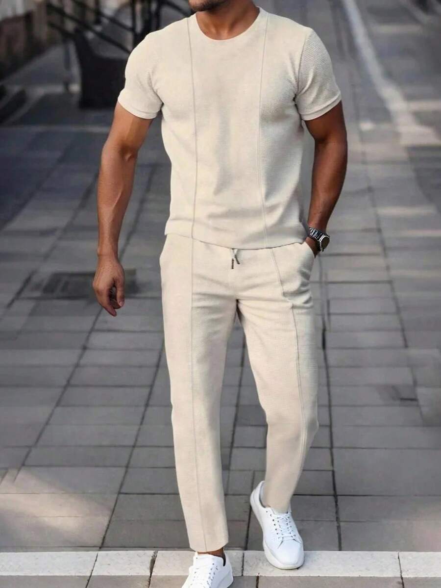 Manfinity Homme Bộ 2 món áo thun tay ngắn màu be trơn thường ngày cho nam và quần dài, trang phục mùa hè phối màu kem. Món quà tuyệt vời cho bạn trai hoặc chồng. Trang phục ấm áp - Màu be - Xem 1