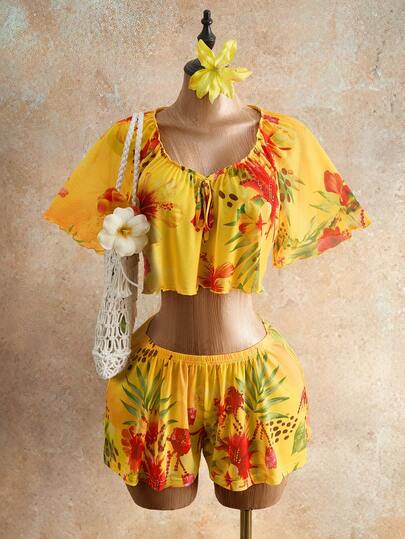 Mistrie 2026 Frau Sommers neues sexy V-Ausschnitt Einschulter Kleid mit Sonnen- und Blumenmuster, ein Paar Shorts mit Blumendruck, YK2 verspielter Strandoutfit, aus fließendem und atmungsaktivem leichtem Stoff, geeignet für Strandurlaube, Musikfestivals, Abschlussfeier und verschiedene Feiertage.