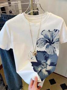 INAWLY 大码女式短袖T恤，水彩花卉印花，休闲百搭的圆领宽松上衣，尽显夏日度假风情。艺术感十足的修身基础款T恤，适合日常通勤和约会等场合。短袖设计清新淡雅，彰显年轻活力，舒适透气的剪裁在韩国广受欢迎。简约时尚的T恤，日常出行必备，也是送给女友和母亲节的理想礼物。 - 白色 - 查看 1