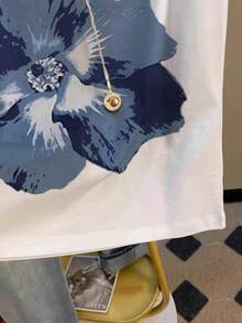 INAWLY 大码女式短袖T恤，水彩花卉印花，休闲百搭的圆领宽松上衣，尽显夏日度假风情。艺术感十足的修身基础款T恤，适合日常通勤和约会等场合。短袖设计清新淡雅，彰显年轻活力，舒适透气的剪裁在韩国广受欢迎。简约时尚的T恤，日常出行必备，也是送给女友和母亲节的理想礼物。 - 白色 - 查看 5