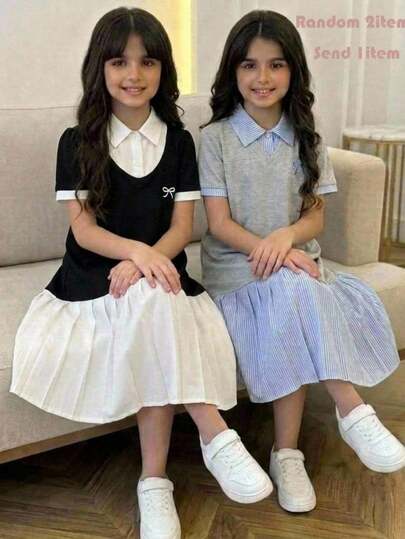 少女学院风拼接连衣裙，黑色针织上衣为主体，搭配清新白色领口和袖口，领口饰有可爱蝴蝶结，条纹百褶裙摆与上衣相呼应，整体风格清新青春，适合日常通勤或休闲外出穿着。