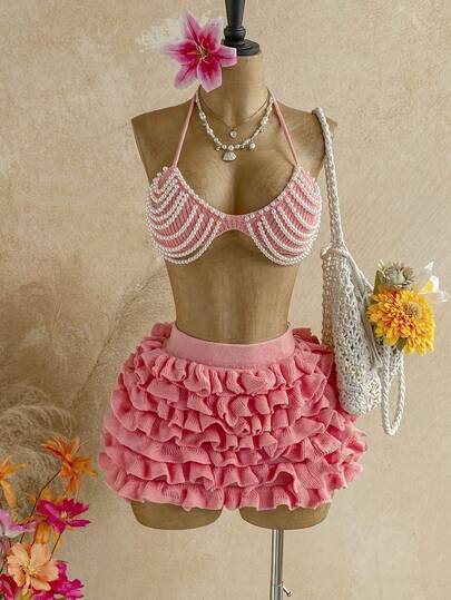Soleia Bộ 2 món gồm áo croptop và chân váy midi dệt kim đính ngọc trai dành cho nữ.