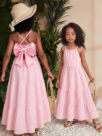Sparklyn Girls' Summer New Spaghetti Strap Backless Dress With Big Bow Decor, Sleeveless Flowy A-Line Textured Fabric, Minimalist Red Dopamine Dress For Vacation