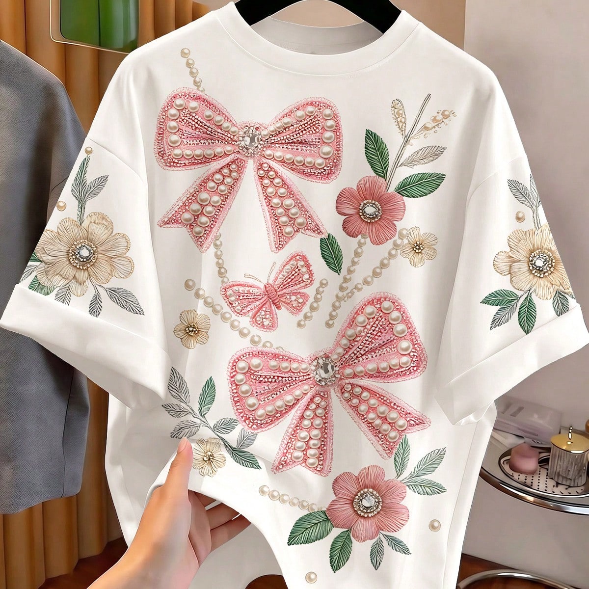 Camiseta de manga corta con cuello redondo y estampado de lazos rosa para niña preadolescente